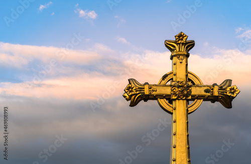 The historic gilded cross in front of the Basilica of the Apparitions of Mary in Lourdes, France