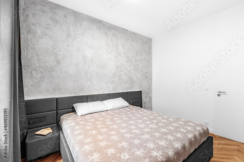 Luxury bedroom with concrete wall and wooden floor