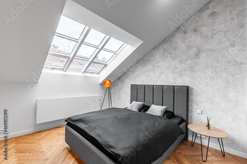 Luxury bedroom with concrete wall and wooden floor