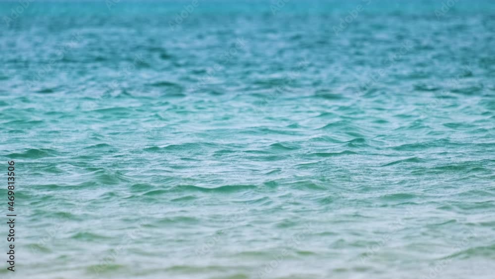 Closeup seascape surface of blue sea water with small ripple waves Closeup seascape surface of blue sea water with small ripple waves