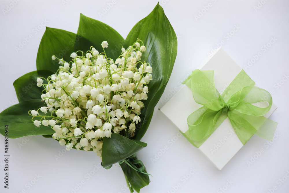 romantic composition. spring greeting card. small bouquet of lilies of the valley and gift box. postcard layout. spring flowers romantic composition. spring greeting card. small bouquet of lilies of the valley and gift box. postcard layout. spring flowers