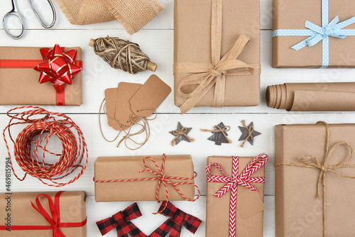 Christmas Flat Lay - Plain brown kraft paper wrapped presents with accessories filling the entire frame.