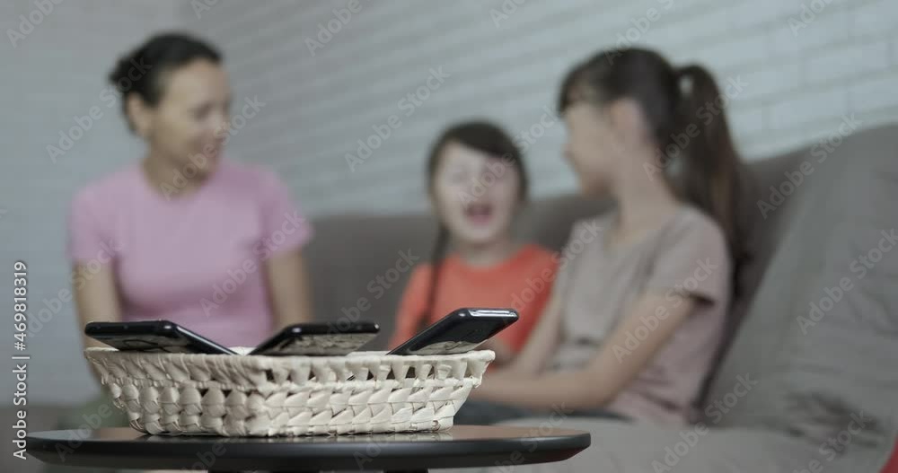 Modern mother speak with daughters. A woman has funny time with her daughters without gadgets in the room. Modern mother speak with daughters. A woman has funny time with her daughters without gadgets in the room.
