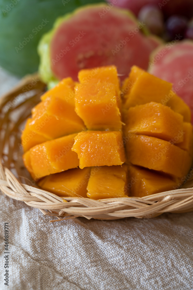 Exotic fruits of Cyprus, fresh yellow juicy mango, ripe pink guava, bananas and sweet table grapes Exotic fruits of Cyprus, fresh yellow juicy mango, ripe pink guava, bananas and sweet table grapes