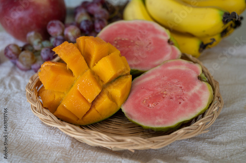 Exotic fruits of Cyprus, fresh ripe pink guava, yellow juicy mango, bananas and sweet table grapes