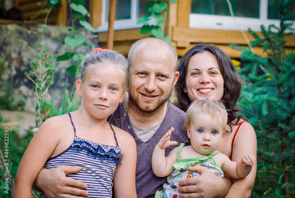 Portrait of happy family against house