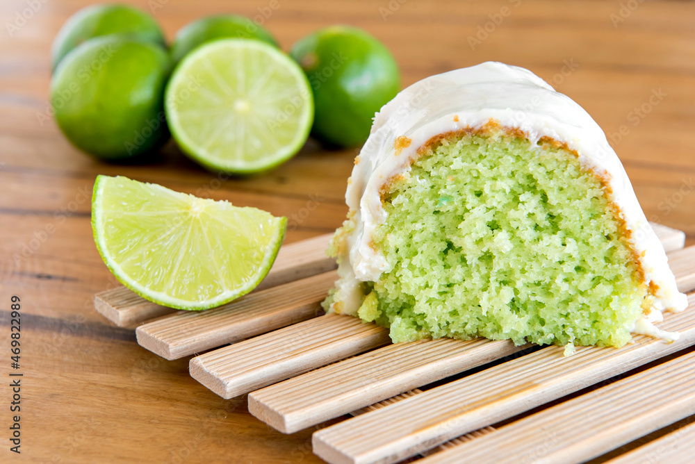 Lemon cake with lemon wedges on wooden background. Lemon cake with lemon wedges on wooden background.