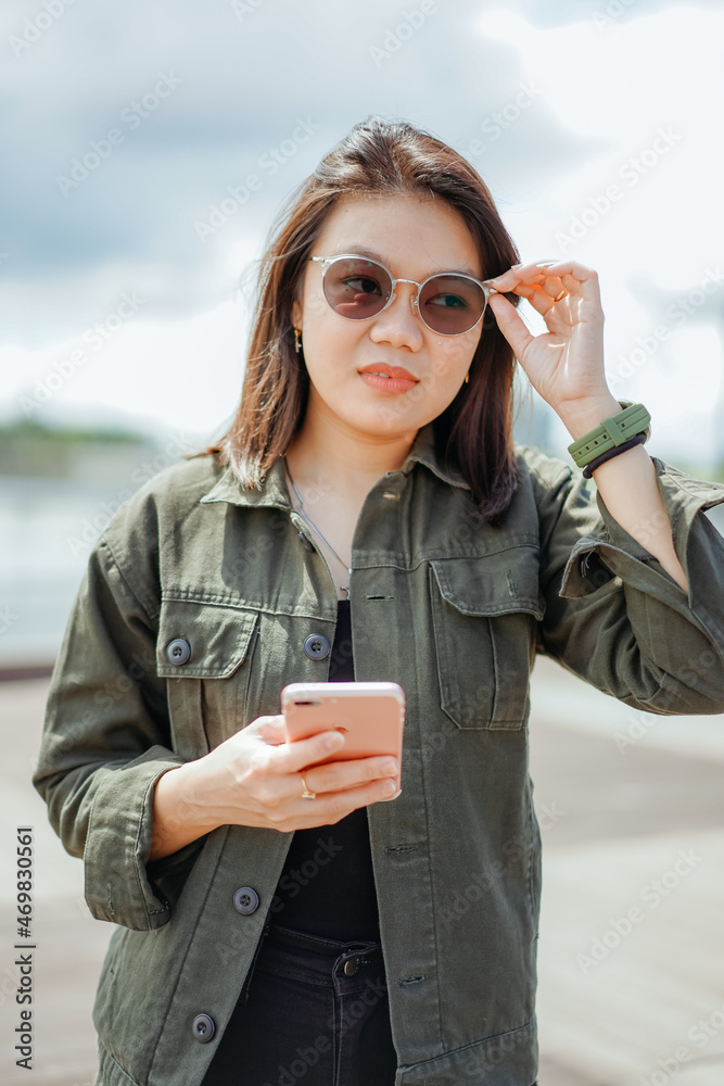 Using Smartphone of Young Beautiful Asian Woman Wearing Jacket And ...