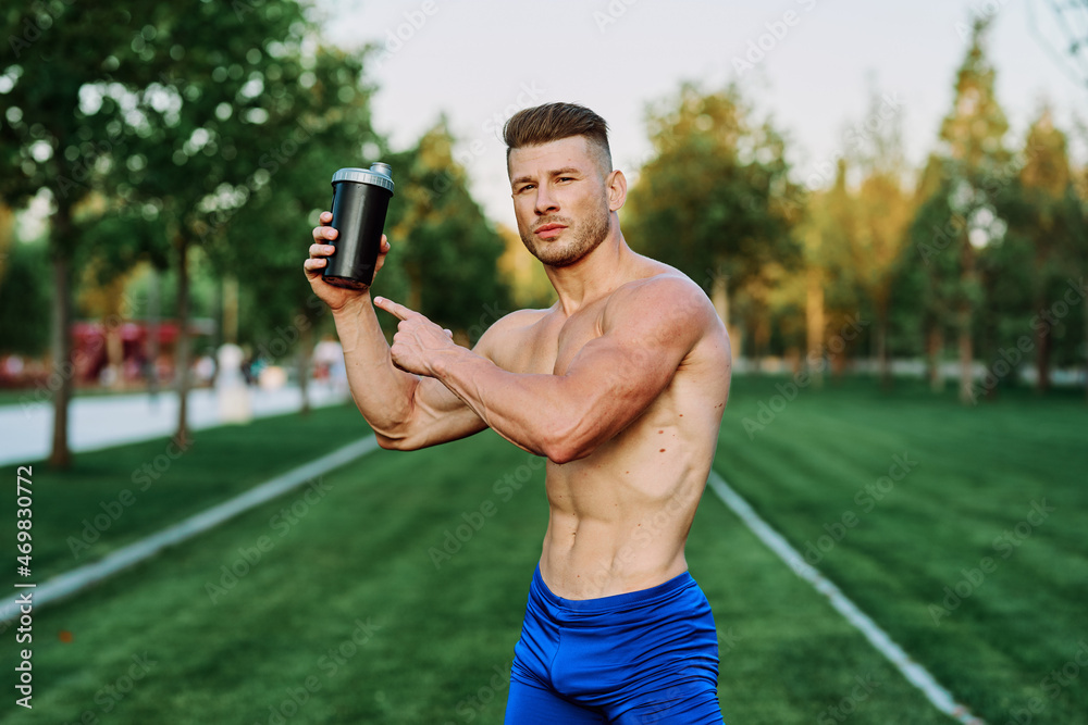 athletic man with pumped up muscular body in the park exercise workout motivation athletic man with pumped up muscular body in the park exercise workout motivation