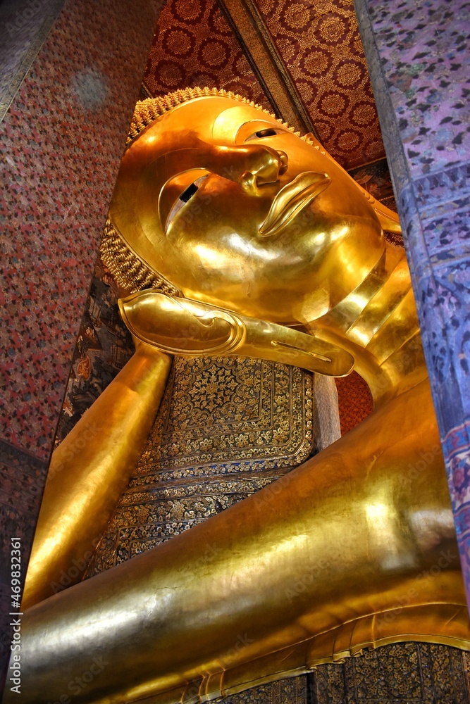 The big golden reclining buddha at Wat Pho or Wat Phra Chetuphon Wimon Mangkhalaram Rajwaramahawihan, Buddhist temple in Bangkok, Thailand.