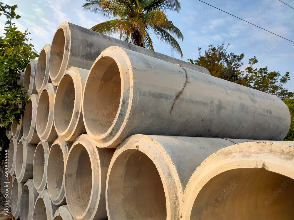 stacked of concrete pipes, cement pipes. concrete pipes for irrigation at construction site stacked of concrete pipes, cement pipes. concrete pipes for irrigation at construction site