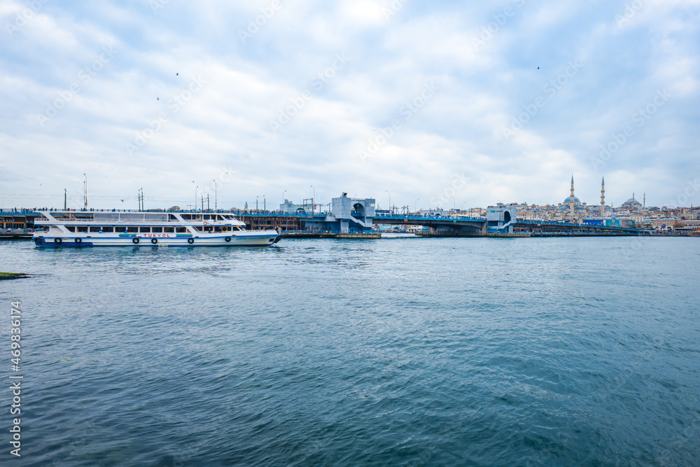 Istanbul cityscape with Galata bridge and Hagia Sophia in the background.  Bosphorus ferry and cruise view in in the strait of Istanbul.