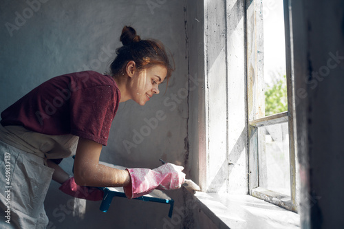 woman painter paint window home interior renovation