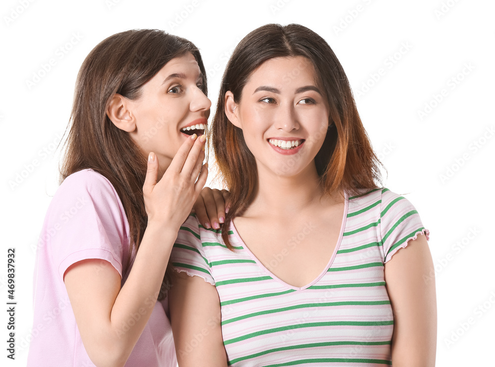 Young gossiping women on white background Young gossiping women on white background