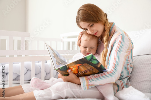 Young mother reading book t...