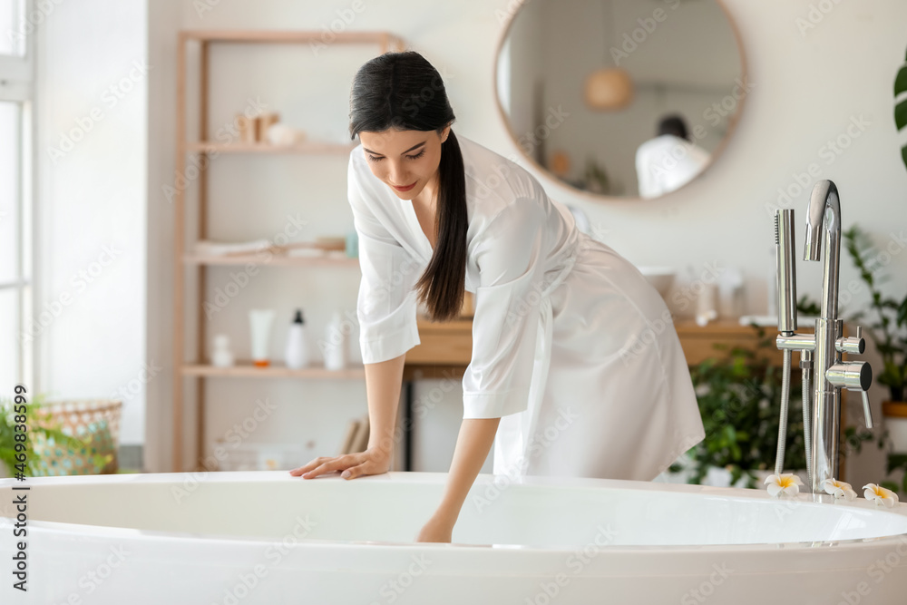 Pretty young woman getting ready to take bath at home Stock Photo