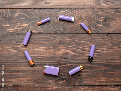 Frame made of alkaline batteries on wooden background photo