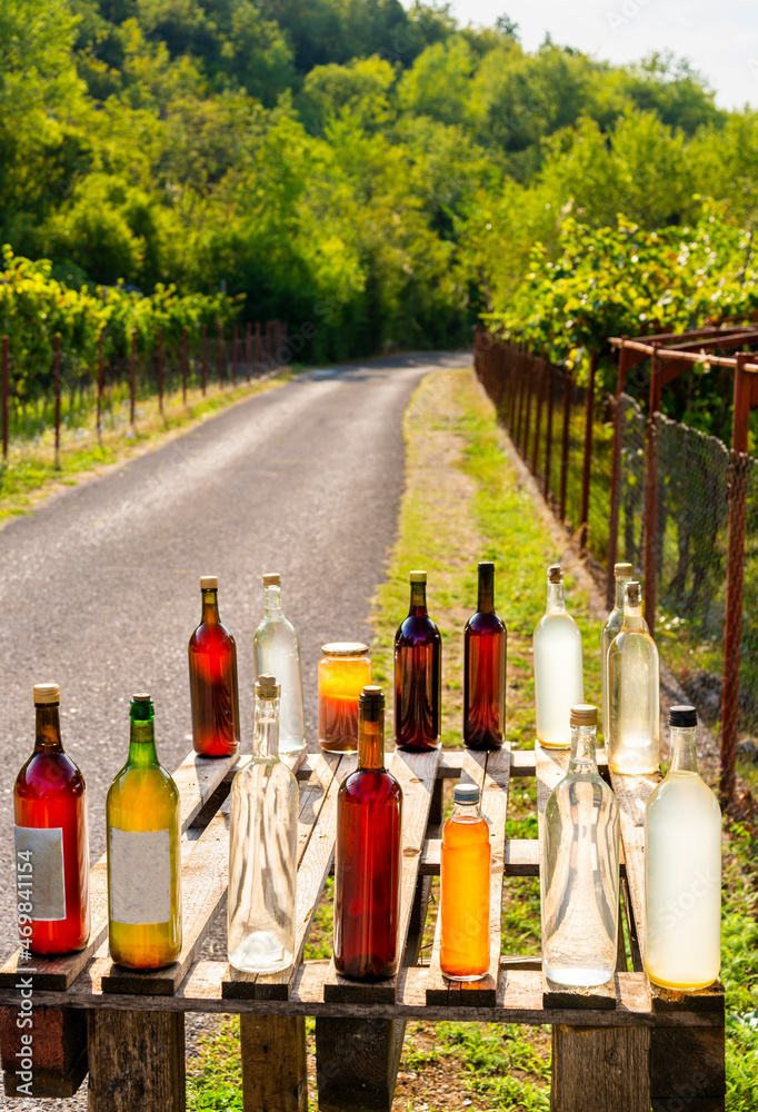 Homemade honey and wine for sale on the roadside,in the morning sun, near lake Skadar,Montenegro.