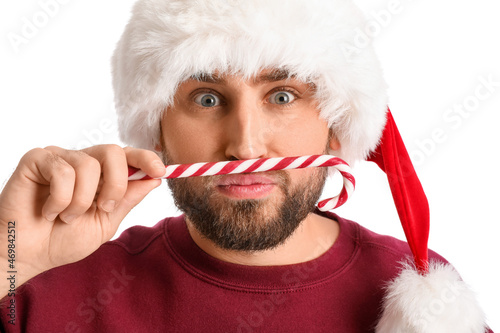 Handsome man in Santa hat w...