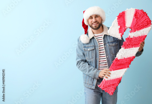 Handsome man in Santa hat w...