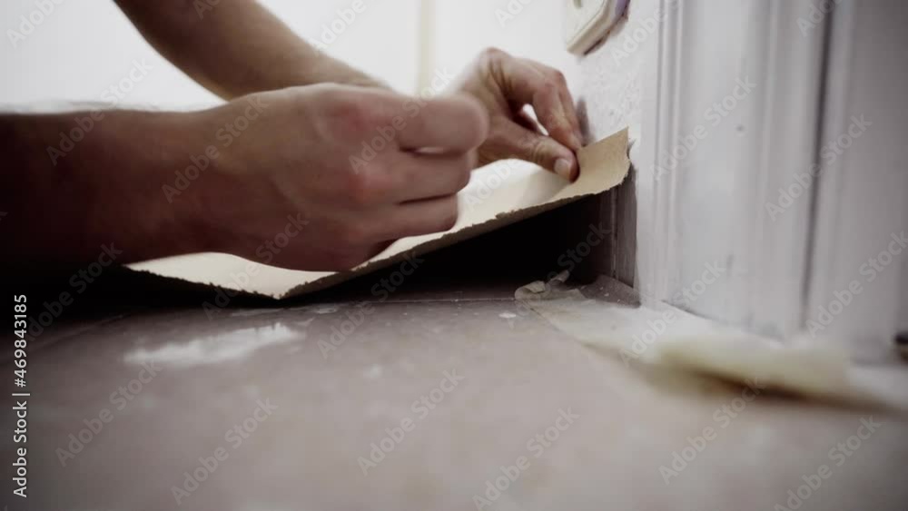 Adding masking tape to cover flooring walls Adding masking tape to cover flooring walls