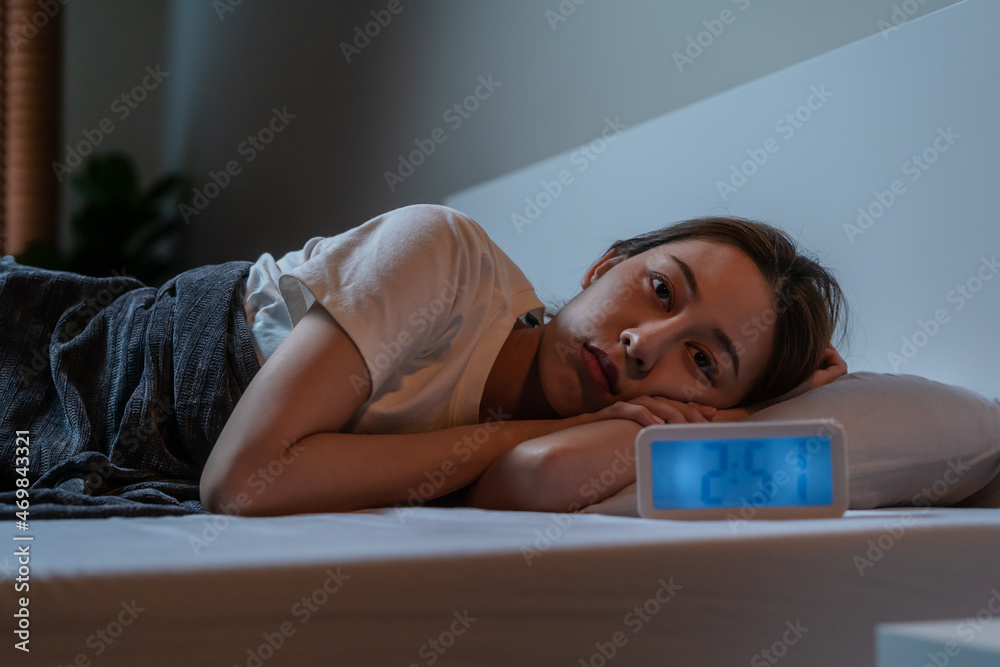 Obraz premium Sad worried and stressed, asian young beautiful, pretty woman, girl suffering from insomnia, awake in the night in bedroom, tired and exhausted. Frustrated people with problem, exhausted on nightmares