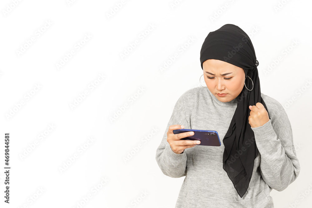 Playing mobile game on Smartphone of Beautiful Asian Woman Wearing Hijab Isolated On White Background Playing mobile game on Smartphone of Beautiful Asian Woman Wearing Hijab Isolated On White Background