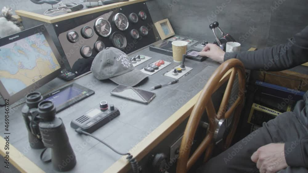 Modern yacht steering helm with dashboard filled with instrument and dials