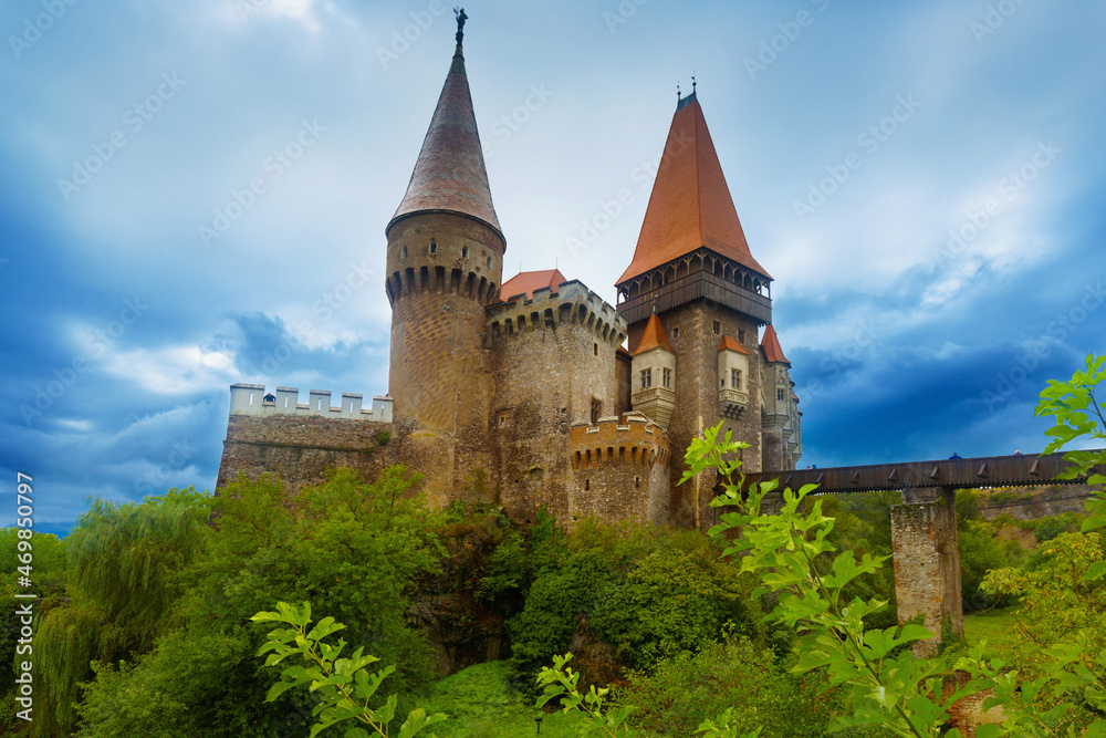 Corvin Castle is on the green mountain of Romania.