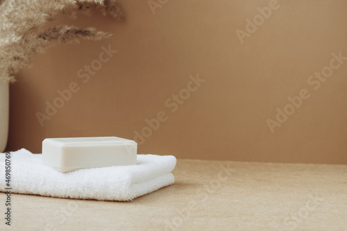 Fototapeta Naklejka Na Ścianę i Meble -  Bars of soap made from natural raw materials white soft towel beige background. Organic cosmetics. Spa health concept