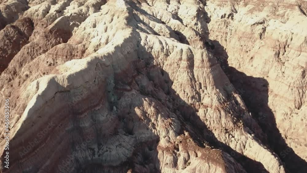 drone shot flying over while camera slowly tilts up over a desert, moonlike landscape somewhere in the West USA in 4k. drone shot flying over while camera slowly tilts up over a desert, moonlike landscape somewhere in the West USA in 4k.