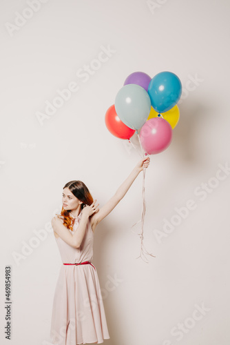 cheerful woman in a dress of colorful balloons