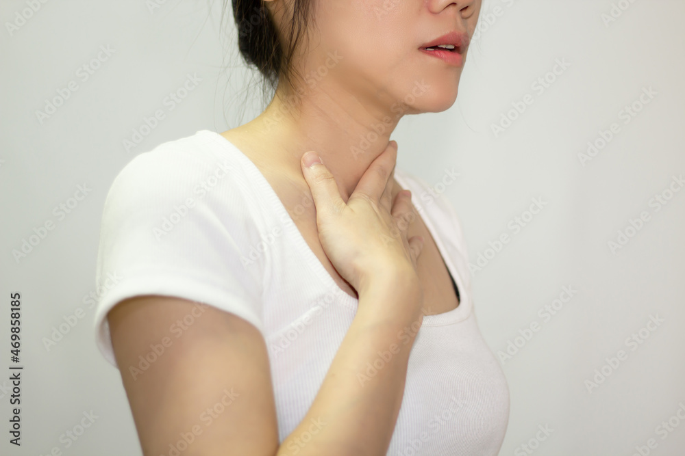 Asian woman using hand touch throat with pain, sore throat and sickness. Asian woman using hand touch throat with pain, sore throat and sickness.