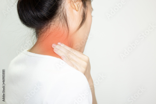 Konstfotografi Asian woman using hand touch her nape with feeling stress and pain caused by bad ergonomic and long hour working