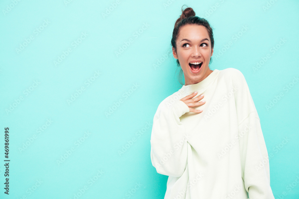 Young beautiful smiling female in trendy summer clothes.Sexy carefree woman posing near blue wall in studio. Positive brunette model having fun and going crazy.Cheerful and happy.Shocked and surprised Young beautiful smiling female in trendy summer clothes.Sexy carefree woman posing near blue wall in studio. Positive brunette model having fun and going crazy.Cheerful and happy.Shocked and surprised