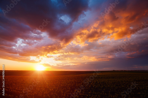 Attractive colorful sunset with cloudy sky in rural area.