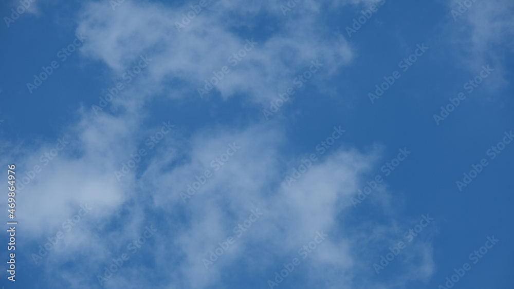 View of beautiful blue sky background with white clouds at the noon, Bangkok, Thailand.