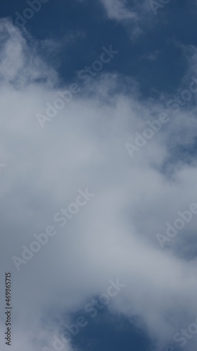 View of beautiful blue sky background with white clouds at the noon, Bangkok, Thailand.
