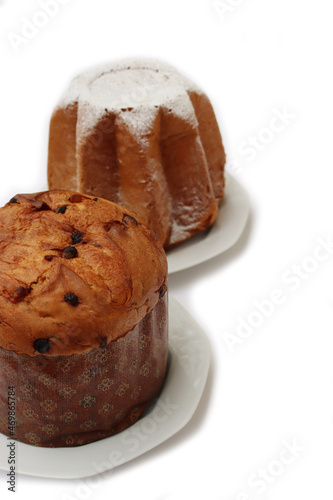 Traditional italian Christmas cakes called Pandoro and Panettone on  plates on white background