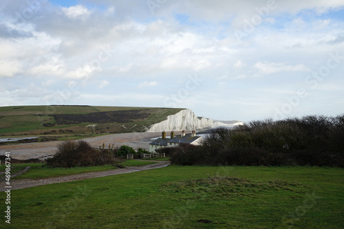 The great views from the top of the Seven Sisters chalk cliffs and national hillsides park with cloudy blue sky- East Sussex, United Kingdom © chettarin