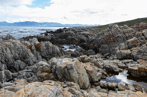 Rocky jagged coastline, eroded sandstone rock, view out to the ocean