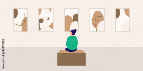 Young Woman Looking At The Paintings In An Art Gallery.
