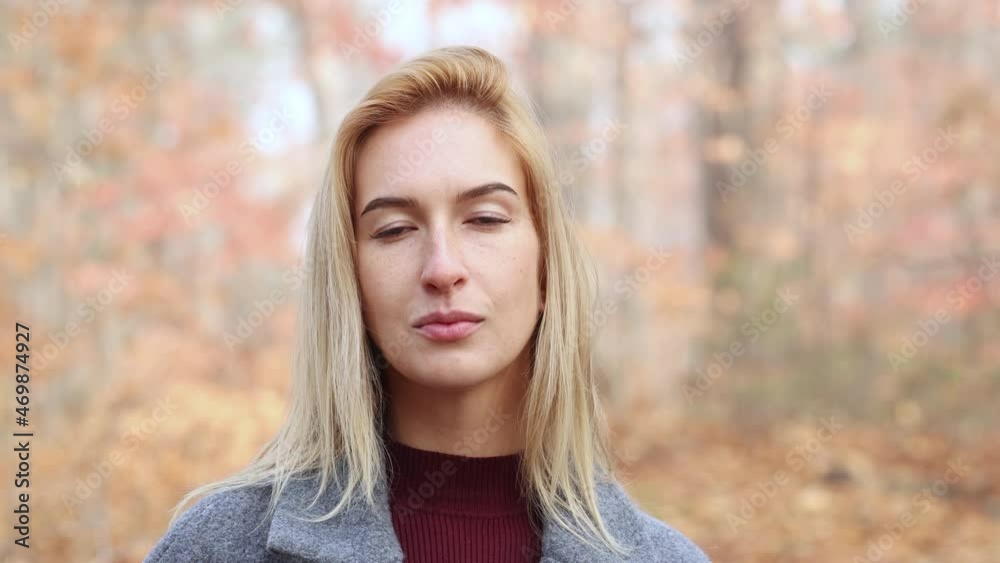 A beautiful European girl looks at the camera in the autumn misty forest. Walk in the fresh air. A beautiful European girl looks at the camera in the autumn misty forest. Walk in the fresh air.
