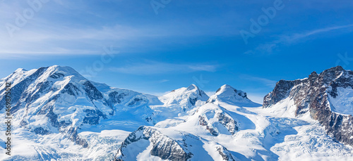 Panoramic of background of Swiss Alps mountain with cloudy and blue sky of banner travel in winter image