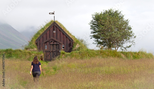 Woman walking towards the Grafarkirkja, a small chapel in Iceland © michaklootwijk