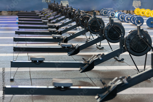 Group of Modern Black Rowing Machine at Gym: Fitness Equipment