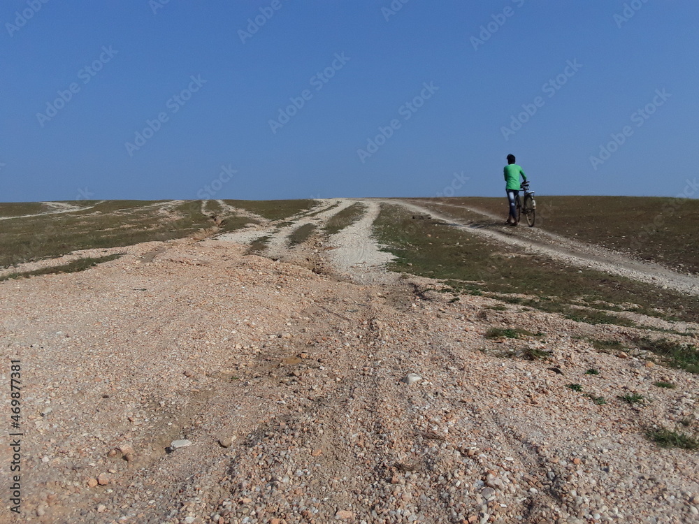 Obraz premium The raw road pictures of scenery at field mountain and village Tourism destination.The raw road pictures of a man person scenery at field mountain and village Tourism destination.Sky background road