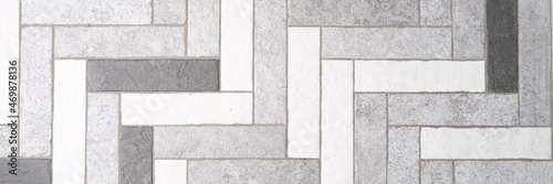 Mosaic floor tiles in rectangles in shades of gray and white closeup photo