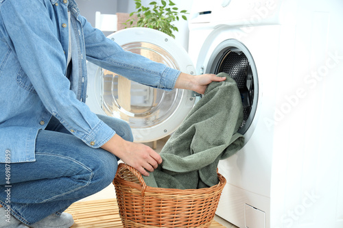 Concept of housework with washing machine and girl on white background photo