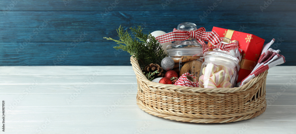 Concept of gift with Christmas basket on white wooden  table